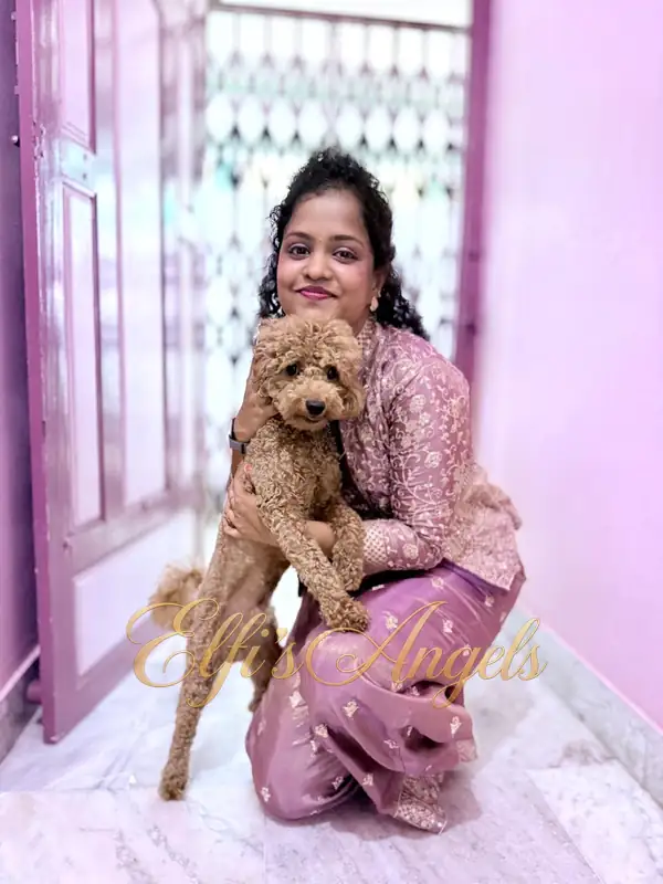 Priya holding Iniyan in a full-length portrait